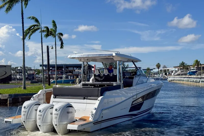 Trade In Yacht Photos Pics 2022 Jeanneau Leader 12.5 WA boat with triple Yamaha engines in a marina setting.