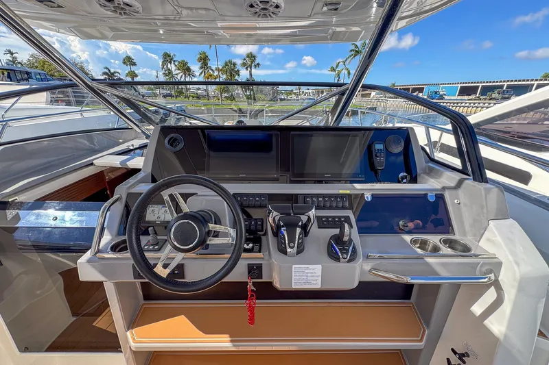 Trade In Yacht Photos Pics Helm of 2022 Jeanneau Leader 12.5 WA with modern controls and navigation system.