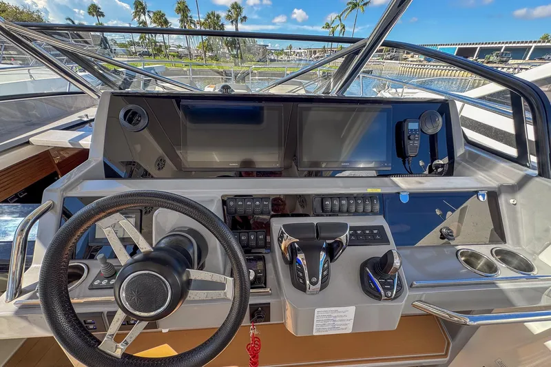 Trade In Yacht Photos Pics Cockpit of 2022 Jeanneau Leader 12.5 WA with modern controls and navigation displays.