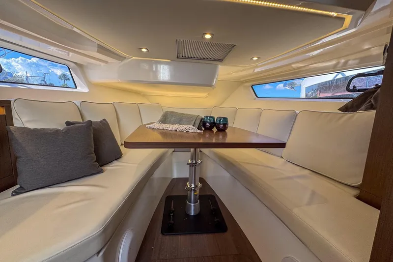Trade In Yacht Photos Pics Luxurious interior of 2022 Jeanneau Leader 12.5 WA with elegant seating and table.