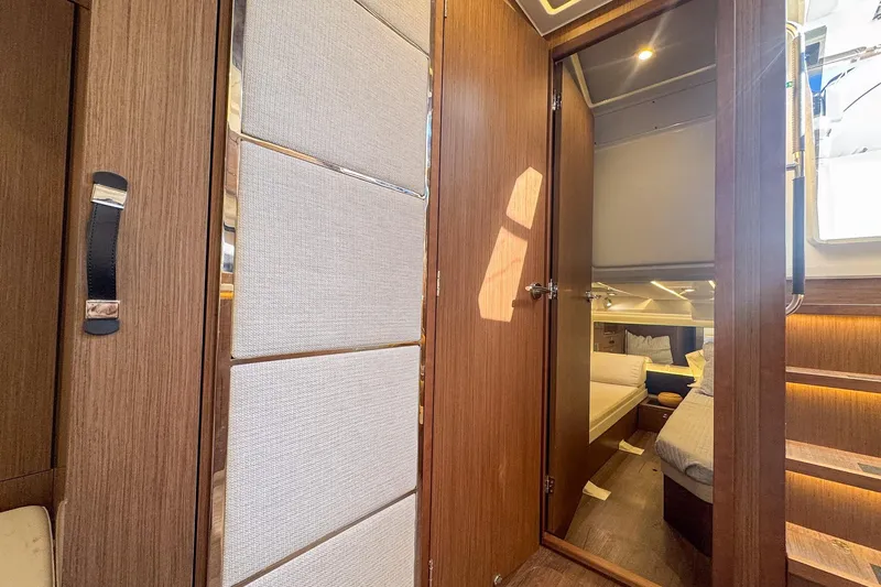 Trade In Yacht Photos Pics Interior cabin of 2022 Jeanneau Leader 12.5 WA, featuring wood paneling and cozy bedding.