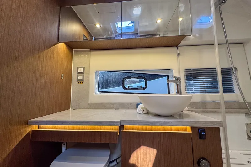 Trade In Yacht Photos Pics Luxurious bathroom interior of 2022 Jeanneau Leader 12.5 WA yacht with modern fixtures.