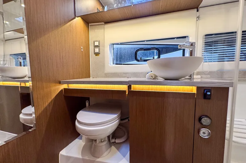 Trade In Yacht Photos Pics Modern bathroom interior of 2022 Jeanneau Leader 12.5 WA yacht, featuring sleek design and amenities.