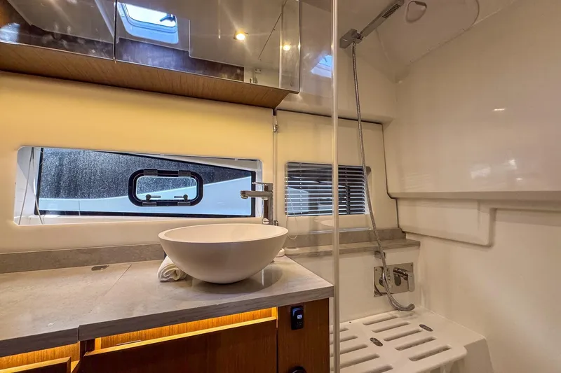 Trade In Yacht Photos Pics Modern bathroom interior of 2022 Jeanneau Leader 12.5 WA yacht with sleek fixtures.