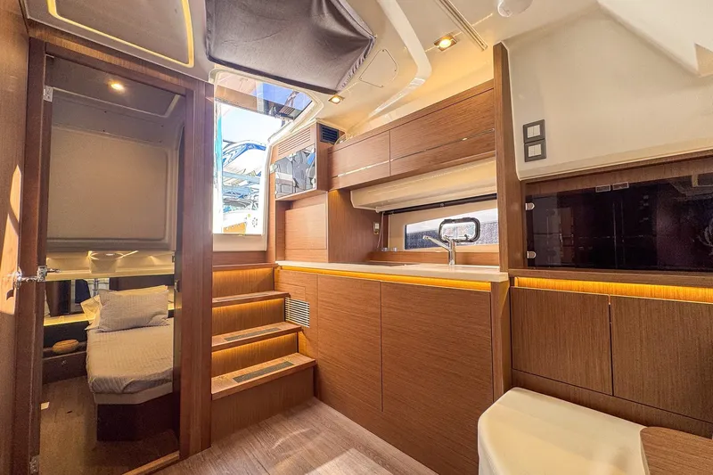 Trade In Yacht Photos Pics Luxurious interior of 2022 Jeanneau Leader 12.5 WA yacht with modern wood finish.