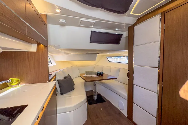 Trade In Yacht Photos Pics Luxurious interior of 2022 Jeanneau Leader 12.5 WA yacht with modern seating and dining area.