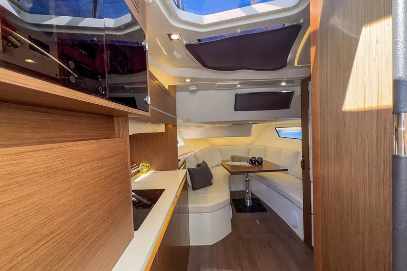 Trade In Yacht Photos Pics Luxurious interior of 2022 Jeanneau Leader 12.5 WA yacht with modern wood finishes.