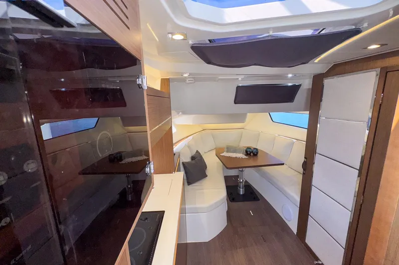 Trade In Yacht Photos Pics Luxurious interior of 2022 Jeanneau Leader 12.5 WA yacht with elegant seating and dining area.