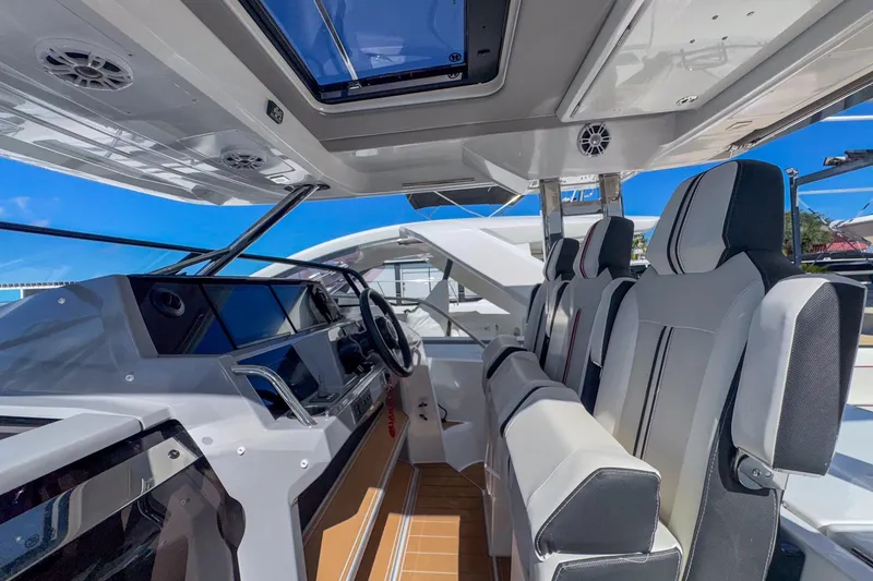 Trade In Yacht Photos Pics Interior of 2022 Jeanneau Leader 12.5 WA boat with modern seating and dashboard.
