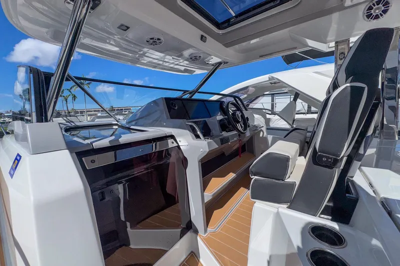 Trade In Yacht Photos Pics 2022 Jeanneau Leader 12.5 WA cockpit with modern helm, seating, and open sky view.
