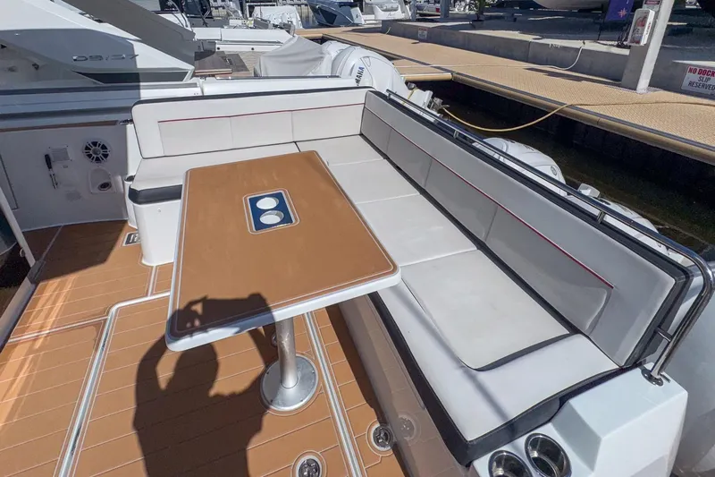Trade In Yacht Photos Pics 2022 Jeanneau Leader 12.5 WA boat deck with seating and table.