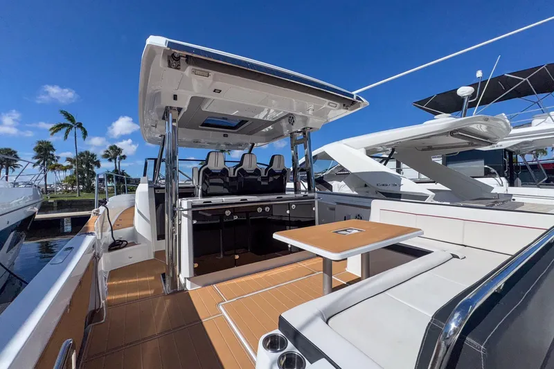 Trade In Yacht Photos Pics 2022 Jeanneau Leader 12.5 WA boat with spacious deck and seating under clear blue sky.