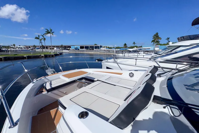 Trade In Yacht Photos Pics 2022 Jeanneau Leader 12.5 WA yacht docked, featuring spacious deck seating under clear blue skies.