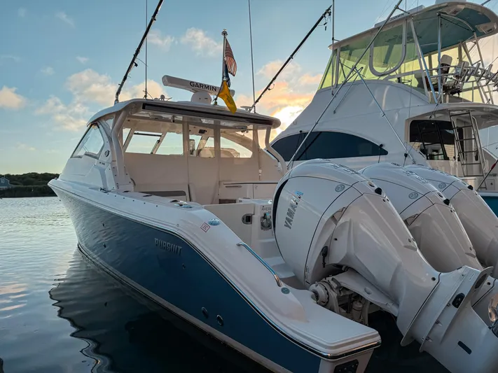  Yacht Photos Pics 2022 Pursuit DC 365 Dual Console boat docked with Yamaha engines at sunset.