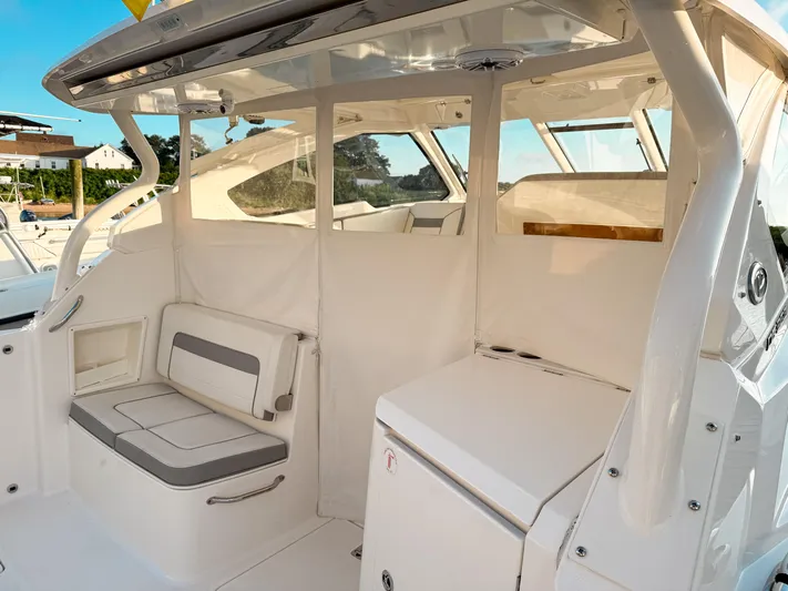  Yacht Photos Pics 2022 Pursuit DC 365 Dual Console boat interior with seating and storage.