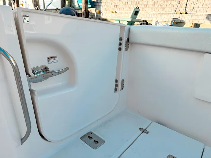  Yacht Photos Pics 2022 Pursuit DC 365 Dual Console boat interior with open hatch and safety warning.