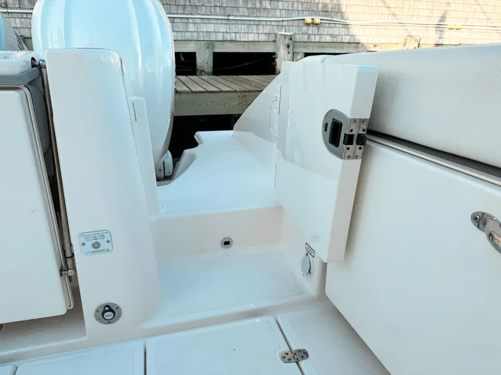  Yacht Photos Pics 2022 Pursuit DC 365 Dual Console boat interior with open storage compartment.