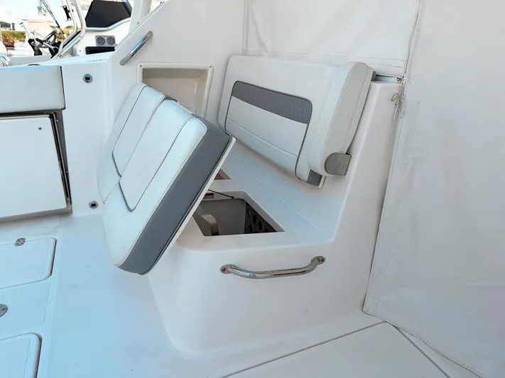 Yacht Photos Pics 2022 Pursuit DC 365 Dual Console boat interior with storage compartment and seating.