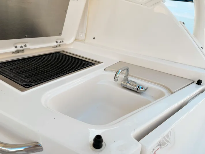  Yacht Photos Pics Pursuit DC 365 Dual Console 2022 boat sink and grill area, featuring sleek design.