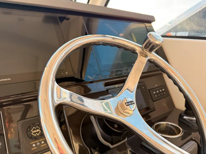  Yacht Photos Pics Steering wheel of 2022 Pursuit DC 365 Dual Console boat with modern dashboard.