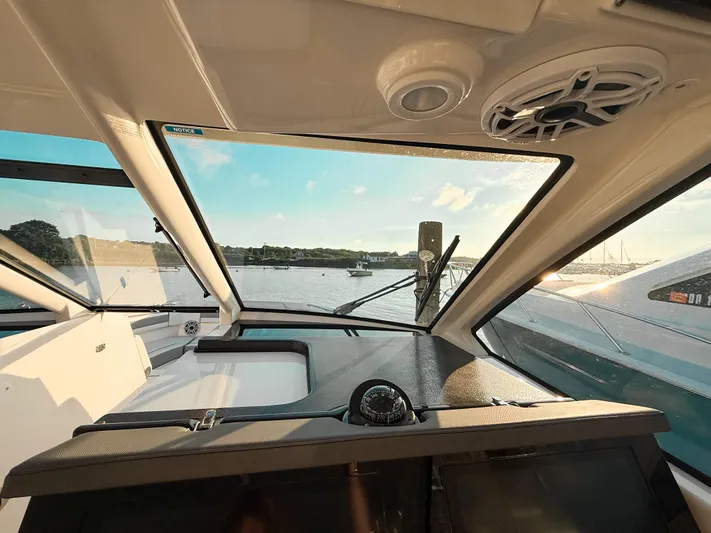  Yacht Photos Pics Interior view of 2022 Pursuit DC 365 Dual Console boat with scenic waterfront.