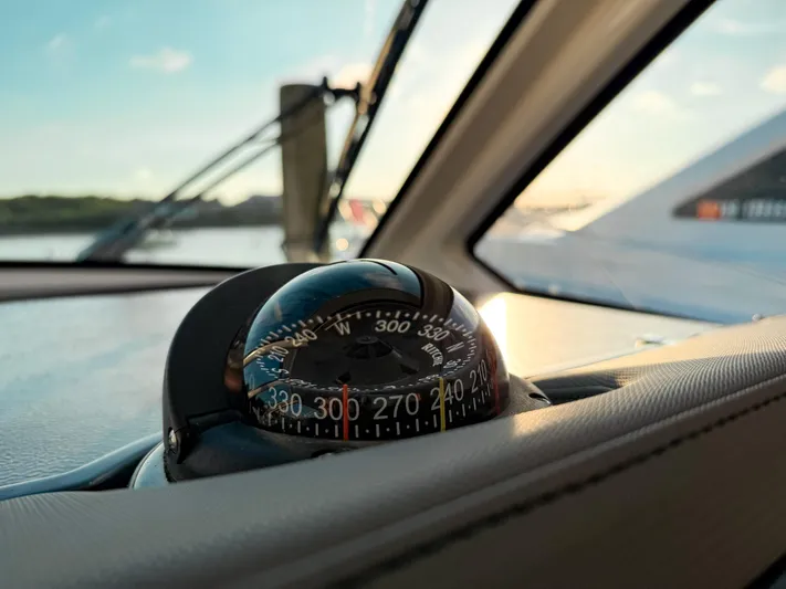  Yacht Photos Pics Compass on 2022 Pursuit DC 365 Dual Console boat, with scenic water view.