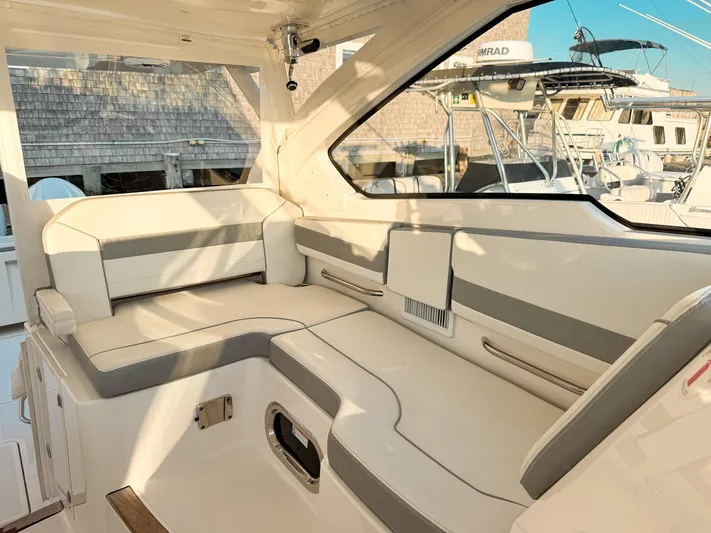  Yacht Photos Pics 2022 Pursuit DC 365 Dual Console boat interior with cushioned seating and modern design.