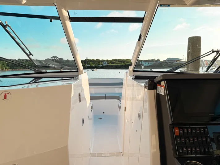  Yacht Photos Pics 2022 Pursuit DC 365 Dual Console boat interior with scenic water view.