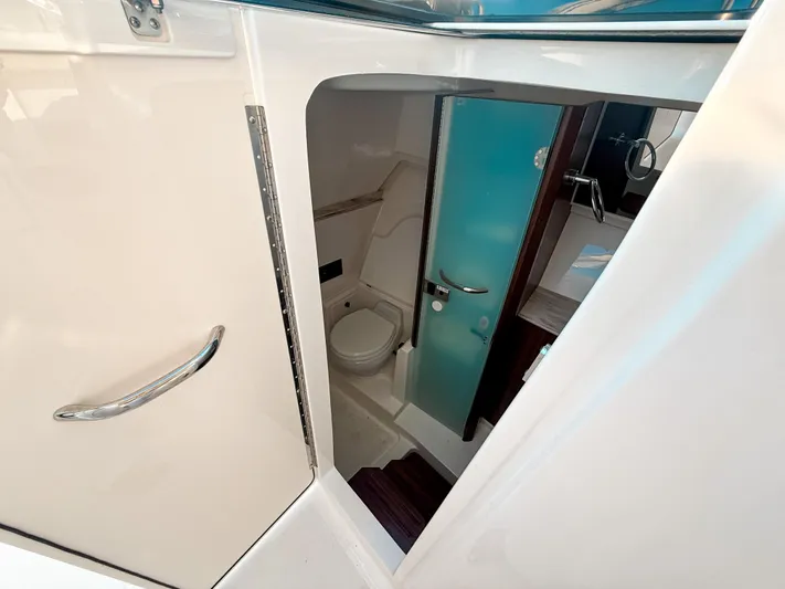  Yacht Photos Pics 2022 Pursuit DC 365 Dual Console boat interior bathroom with modern fixtures and sleek design.