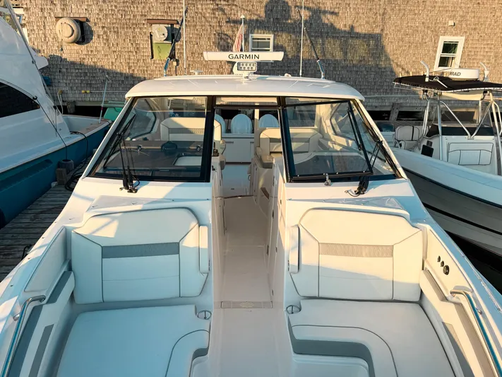  Yacht Photos Pics 2022 Pursuit DC 365 Dual Console boat docked, showcasing spacious seating and modern design.