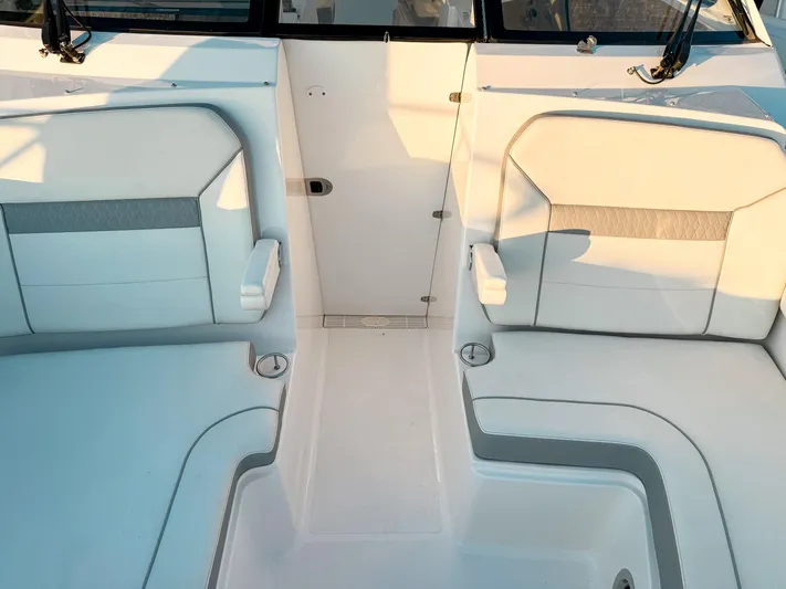  Yacht Photos Pics 2022 Pursuit DC 365 Dual Console boat interior with white cushioned seating.