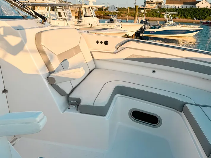  Yacht Photos Pics 2022 Pursuit DC 365 Dual Console boat interior with cushioned seating and cup holder.