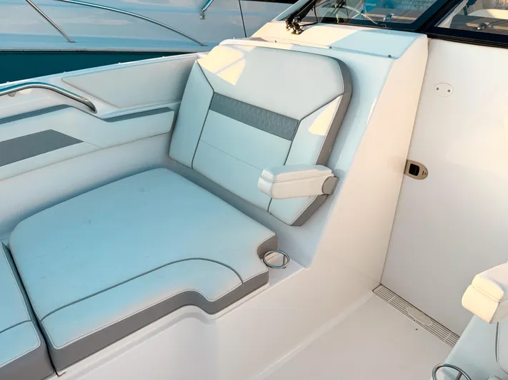  Yacht Photos Pics 2022 Pursuit DC 365 Dual Console boat interior with cushioned seating and armrest.