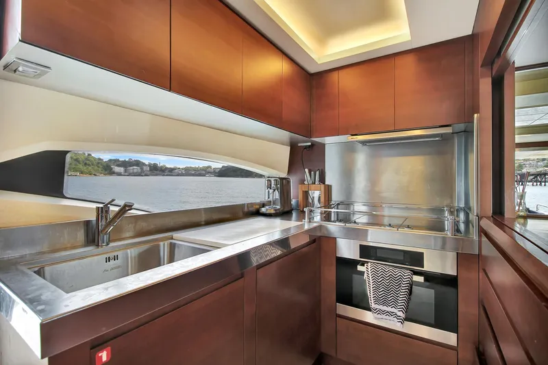  Yacht Photos Pics Luxurious kitchen interior of 2006 Azimut 75 yacht with modern appliances and scenic window view.