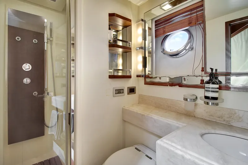  Yacht Photos Pics Luxurious bathroom in a 2006 Azimut 75 yacht, featuring modern fixtures and a porthole window.