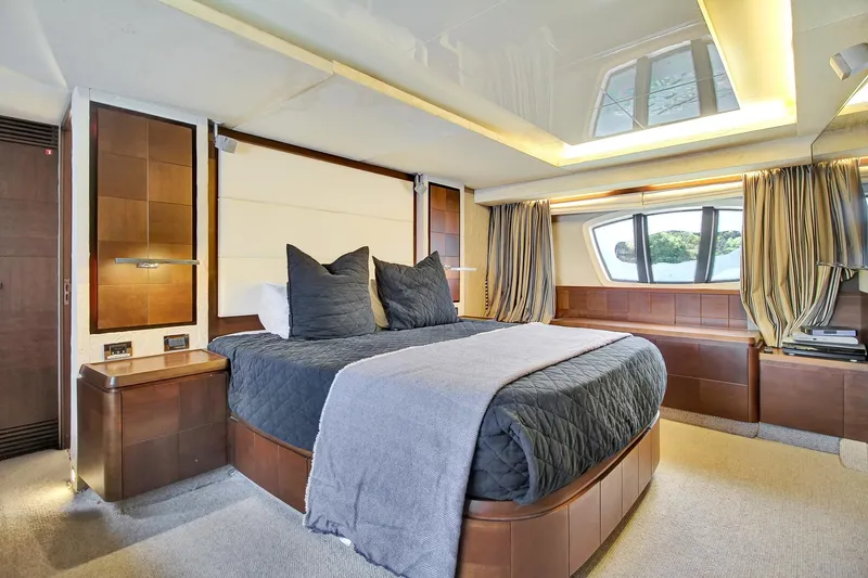  Yacht Photos Pics Luxurious bedroom interior of a 2006 Azimut 75 yacht with modern furnishings and elegant lighting.