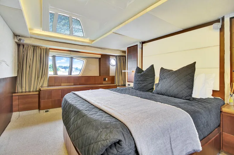  Yacht Photos Pics Luxurious bedroom interior on a 2006 Azimut 75 yacht, featuring elegant bedding and wood accents.