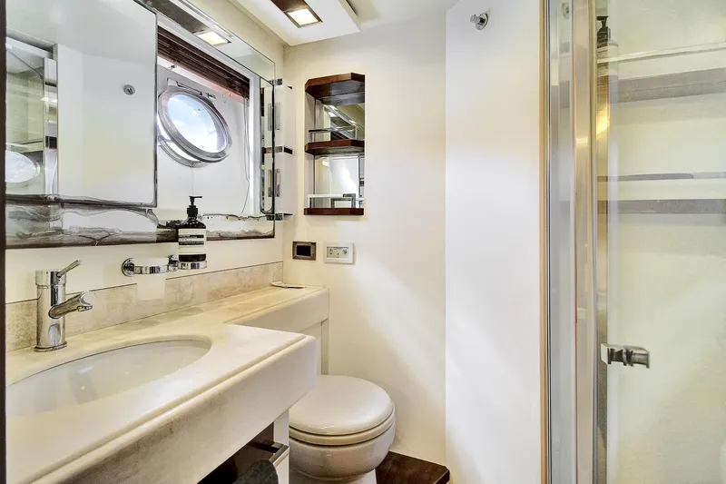  Yacht Photos Pics Luxurious bathroom in 2006 Azimut 75 yacht with modern fixtures and porthole window.