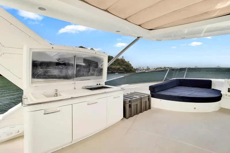  Yacht Photos Pics Luxurious 2006 Azimut 75 yacht deck with seating and kitchenette, ocean view.