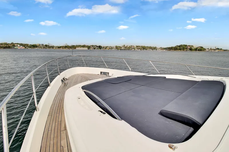  Yacht Photos Pics Azimut 75 yacht bow with sunpad, 2006 model, cruising on calm waters under a clear sky.