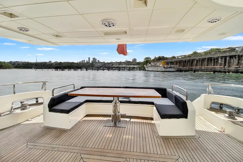  Yacht Photos Pics Luxurious 2006 Azimut 75 yacht deck with seating, table, and scenic waterfront view.