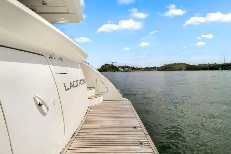  Yacht Photos Pics Luxury Azimut 75 yacht from 2006 docked by serene waters under a clear blue sky.