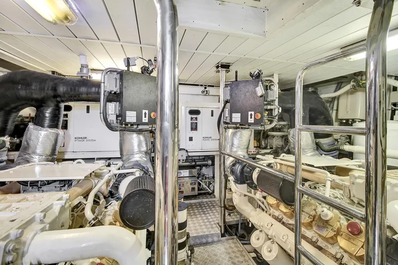  Yacht Photos Pics Engine room of a 2006 Azimut 75 yacht, featuring dual engines and metallic piping.