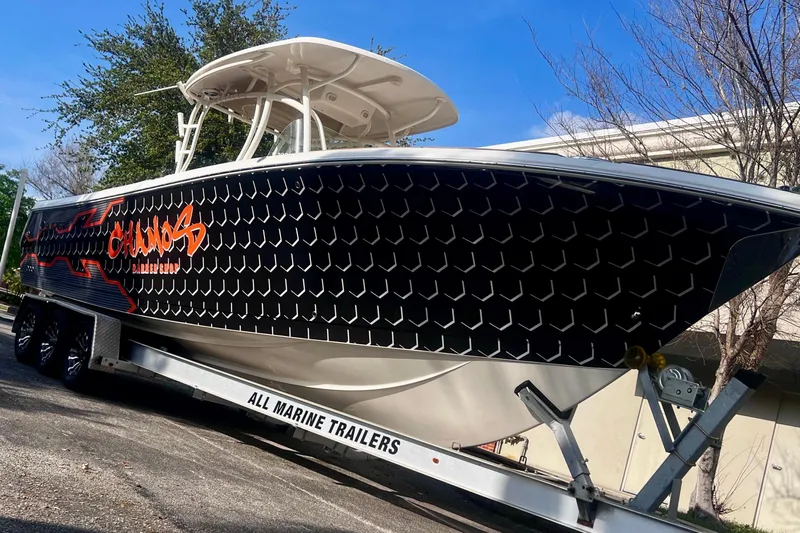  Yacht Photos Pics 2016 Sailfish 290 CC boat on trailer with custom black and orange design.