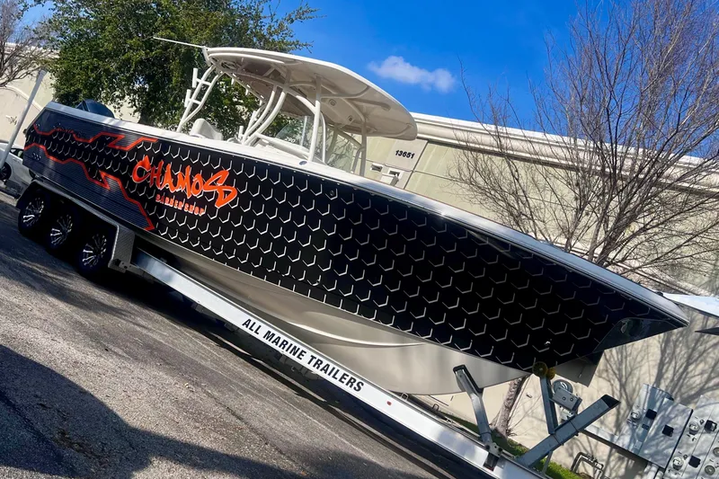  Yacht Photos Pics 2016 Sailfish 290 CC boat on trailer with custom black and orange design.