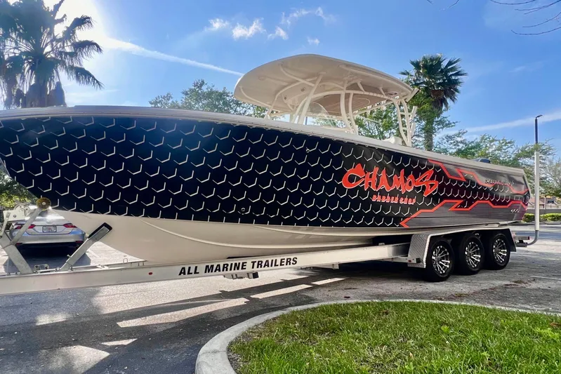  Yacht Photos Pics 2016 Sailfish 290 CC boat on trailer with custom graphics, parked outdoors.