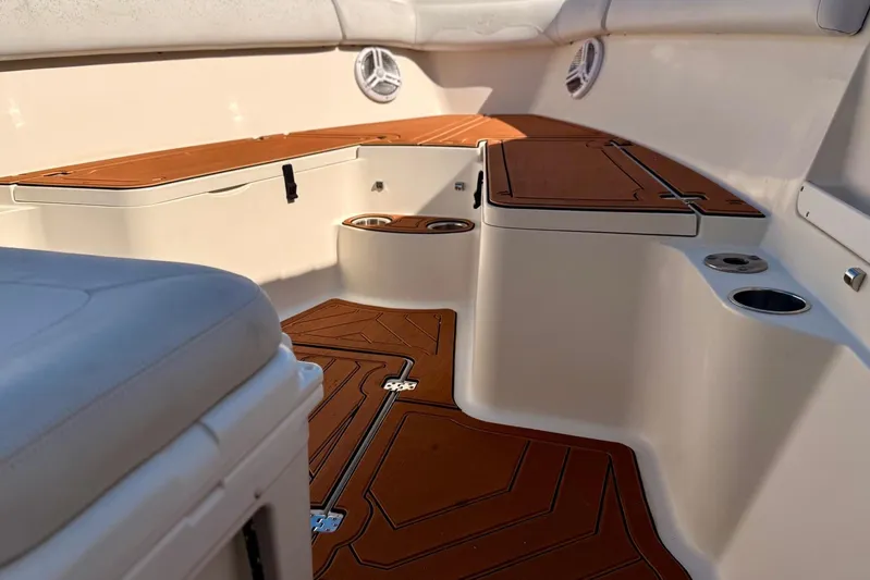  Yacht Photos Pics 2016 Sailfish 290 CC boat interior with cushioned seating and cup holders.