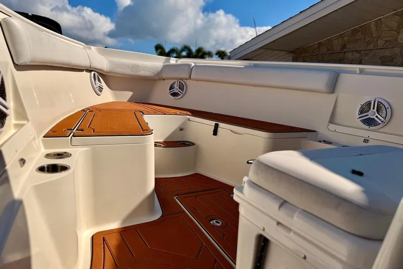  Yacht Photos Pics 2016 Sailfish 290 CC boat interior with teak flooring and cushioned seating.