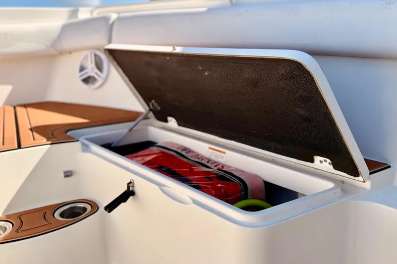  Yacht Photos Pics Open storage compartment on 2016 Sailfish 290 CC boat, showing interior contents.
