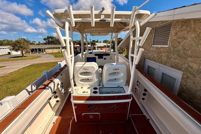  Yacht Photos Pics 2016 Sailfish 290 CC boat interior with seating and rod holders under a blue sky.